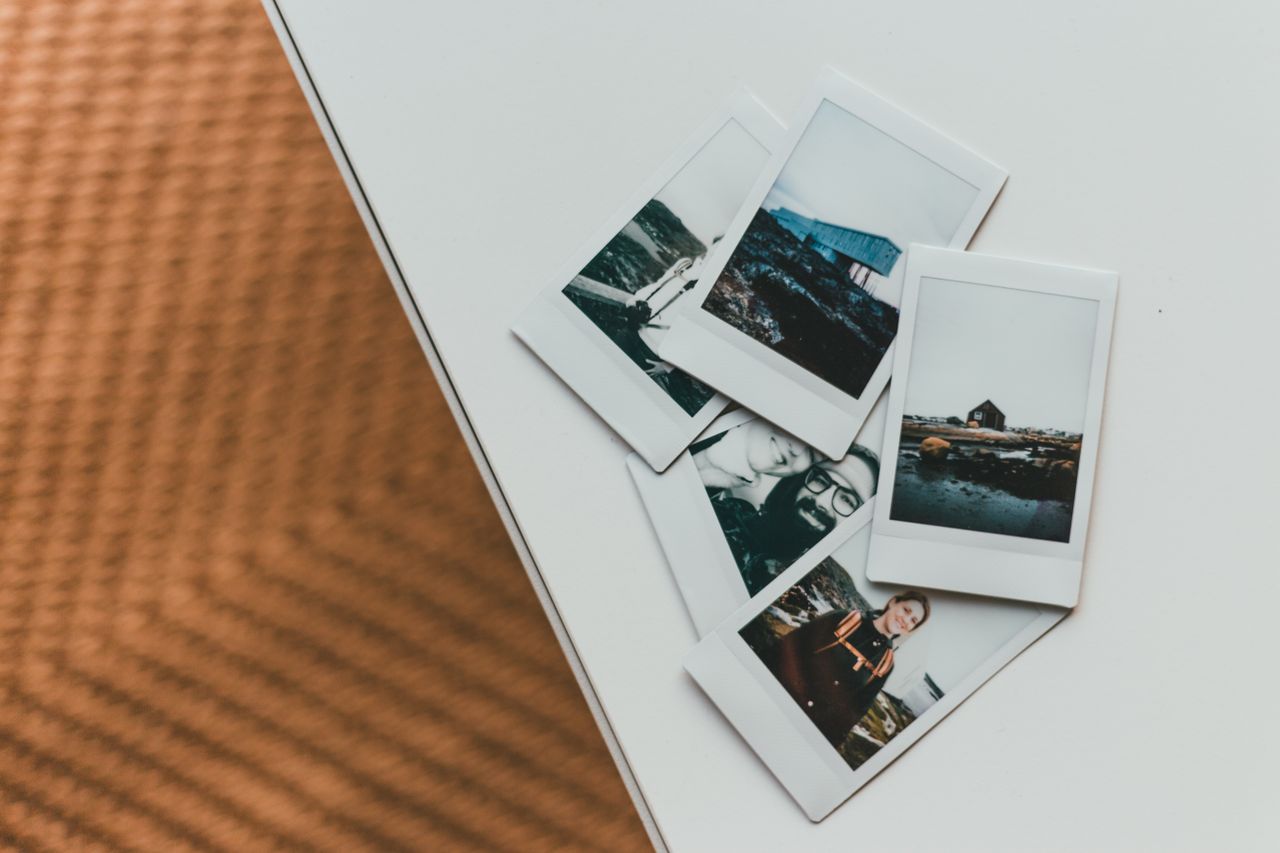 about-02 A collection of Polaroid photos creatively arranged on a modern table.